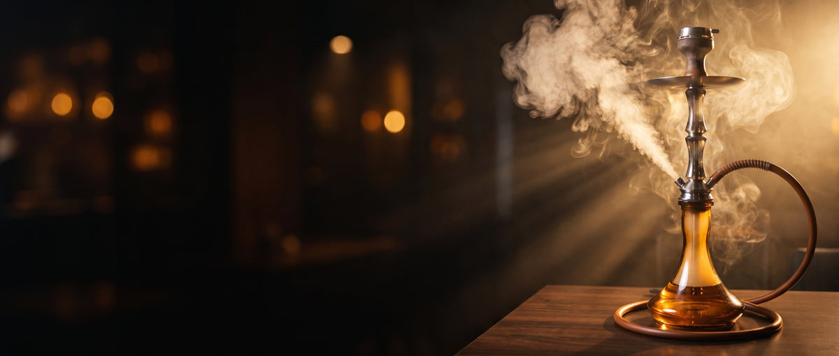 Premium glass hookah with amber base and rising smoke in a warm dark lounge
